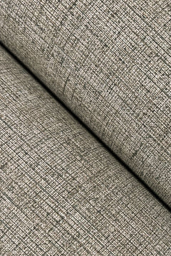 Close-up of Hardy Linen Wallpaper by York Wallcoverings, showcasing its textured, beige surface with a woven, grid-like pattern. The wallpaper is folded diagonally, creating a visible crease and shadow across the image.