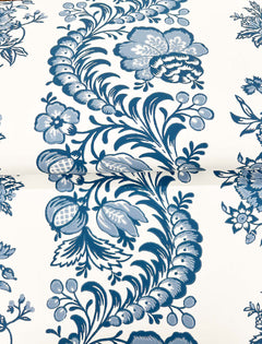 The Beaumont Floral Stripe Wallpaper by York Wallcoverings features a blue and white floral pattern with swirling leaves, flowers, berries, and intricate botanical details set against a light background.