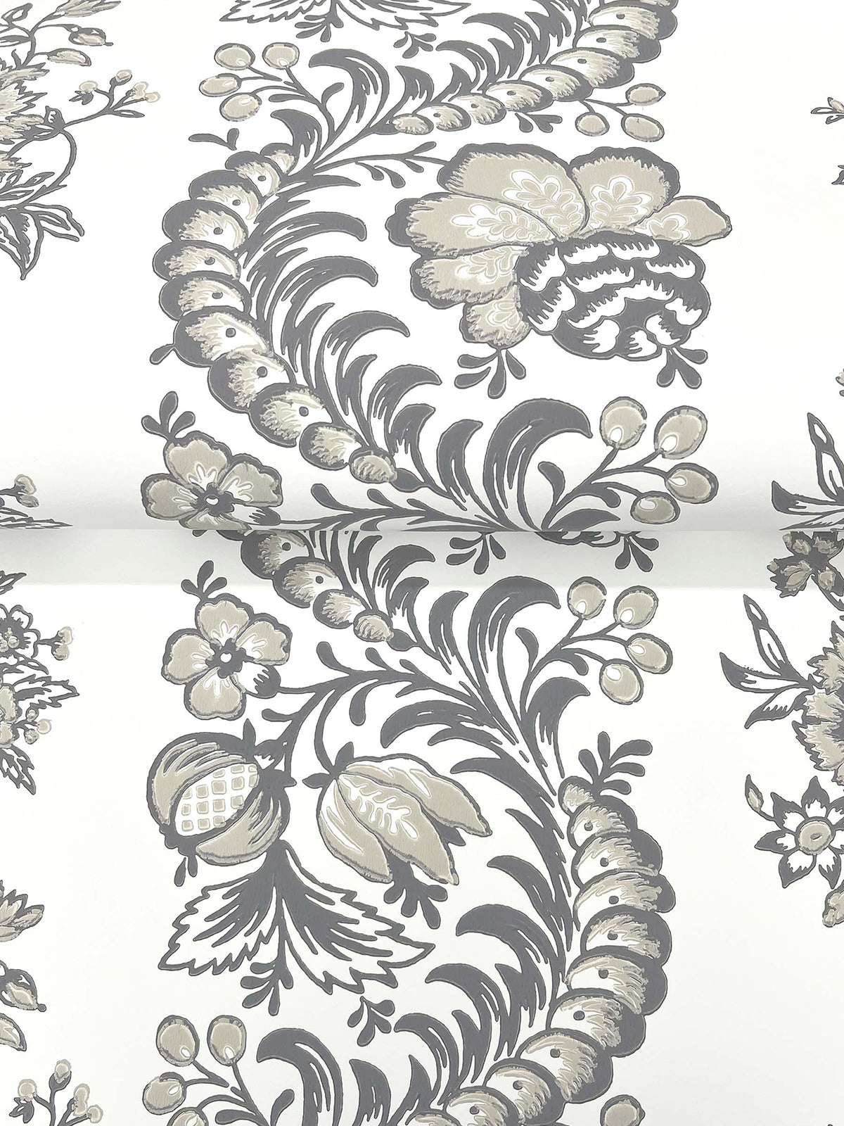 The Beaumont Floral Stripe Wallpaper by York Wallcoverings showcases an elegant combination of gray and beige floral patterns, featuring vintage-inspired flowers, leaves, and berries gracefully arranged on a crisp white background. This timeless design offers a classic and sophisticated look.