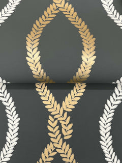 The Laureate Vine Trellis Wallpaper by York Wallcoverings features gold and silver laurel wreath motifs on a dark background, with interlacing gold wreaths at the center and repeating silver wreaths along the sides.