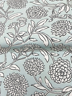 Chatsworth Garden Floral Trail Wallpaper by York Wallcoverings features a light blue background adorned with a black and white floral pattern of large, detailed flowers and leafy stems. The design is shown on gently folded wallpaper.