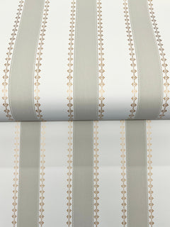 Tilford Awning Stripe Wallpaper by York Wallcoverings features alternating wide gray and white vertical stripes, separated by fine lines of small gold geometric patterns, with a repeating pattern at the visible seam.