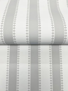 A close-up of the Tilford Awning Stripe Wallpaper by York Wallcoverings, featuring vertical gray and white stripes bordered by small, repeating diamond and dot patterns. The wallpaper is shown partially unrolled on a flat surface.