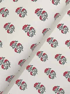 The “Sylvie Floral Wallpaper” by York Wallcoverings features a repeating pattern of red and green floral clusters on a white background, displayed here partially folded at an angle.