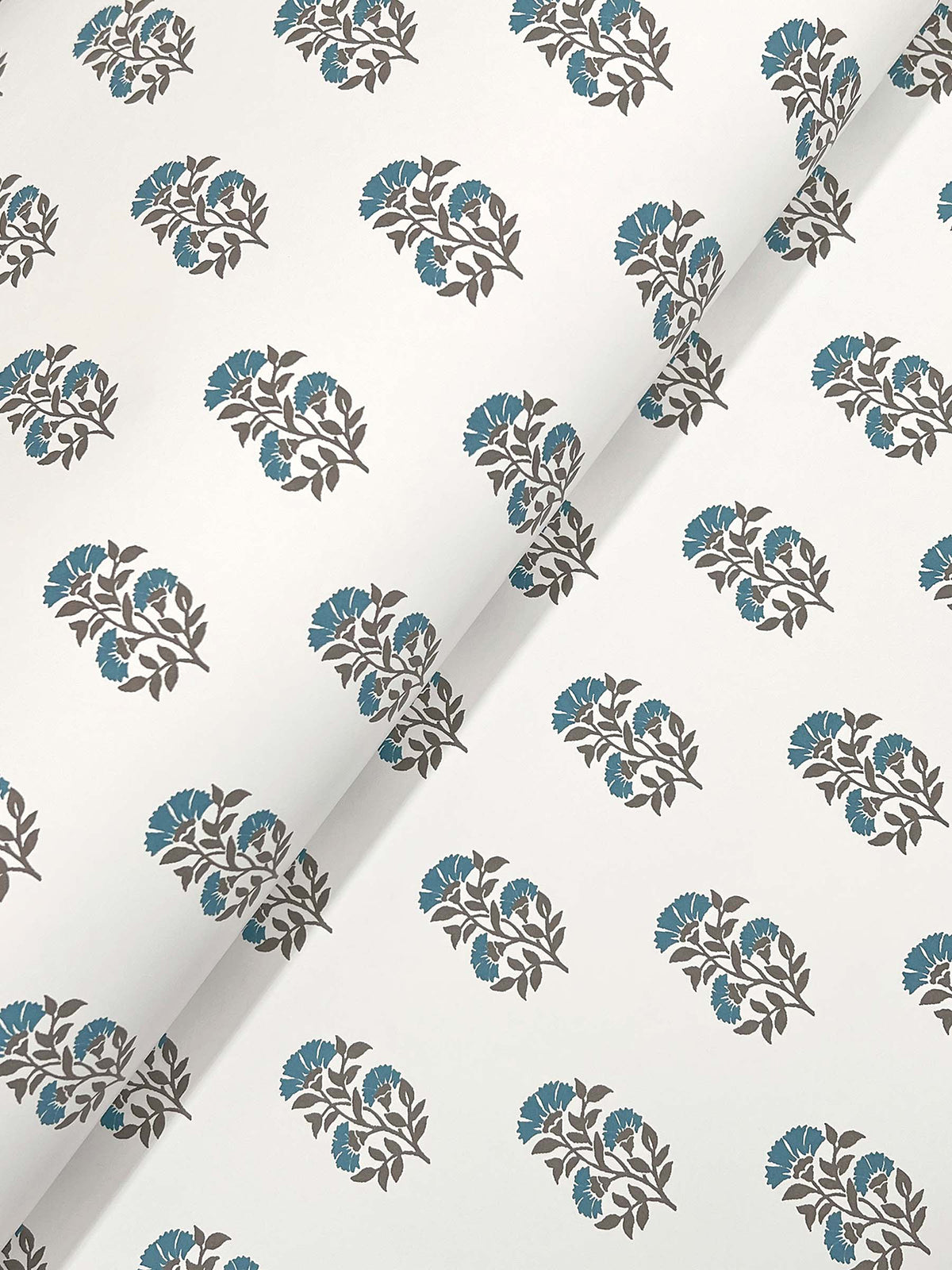 Sylvie Floral Wallpaper by York Wallcoverings features a white background adorned with repeating diagonal rows of blue flowers and dark gray leaves.