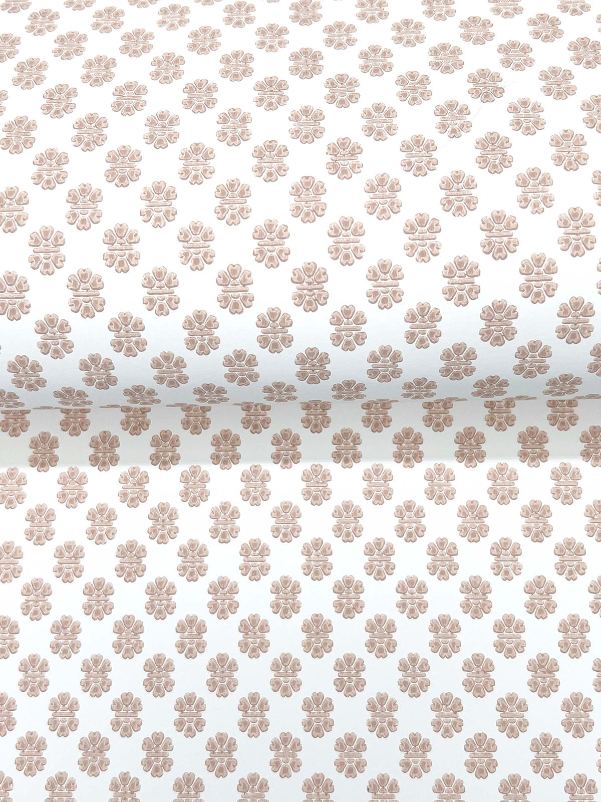 The Brioni Floral Stamp Wallpaper by York Wallcoverings features a repeating pattern of small, light brown floral designs on a white background, with the flowers evenly spaced in a grid-like arrangement.