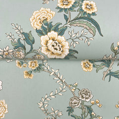 A close-up of the Genevieve Floral Trail Wallpaper by York Wallcoverings, showcasing a vintage floral pattern with yellow, white, and green flowers and leaves on a pale blue background.