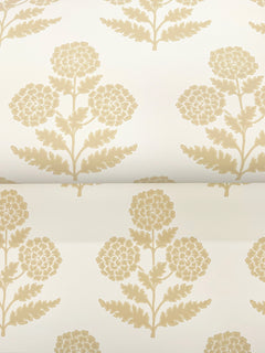 The Souci Marigolds Wallpaper by York Wallcoverings features a beige floral pattern with stylized flowers and leaves, repeated symmetrically and evenly spaced on a light cream background for a classic, elegant look.